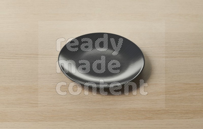 Black Ceramic Circular Plate on Oak Wooden Flooring, 45 degrees
