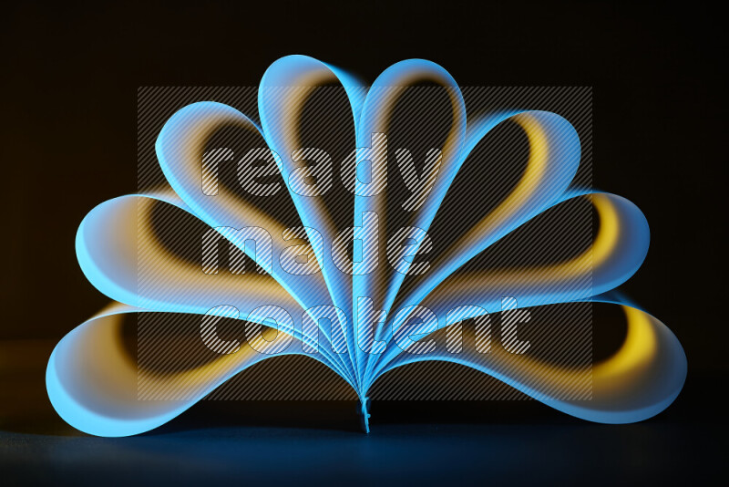 An abstract art piece displaying smooth curves in yellow and blue gradients created by colored light