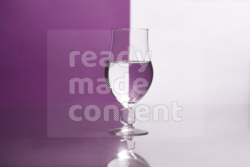 The image features a clear glassware filled with water, set against white and purple background