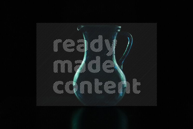 Glassware with rim light in green against black background