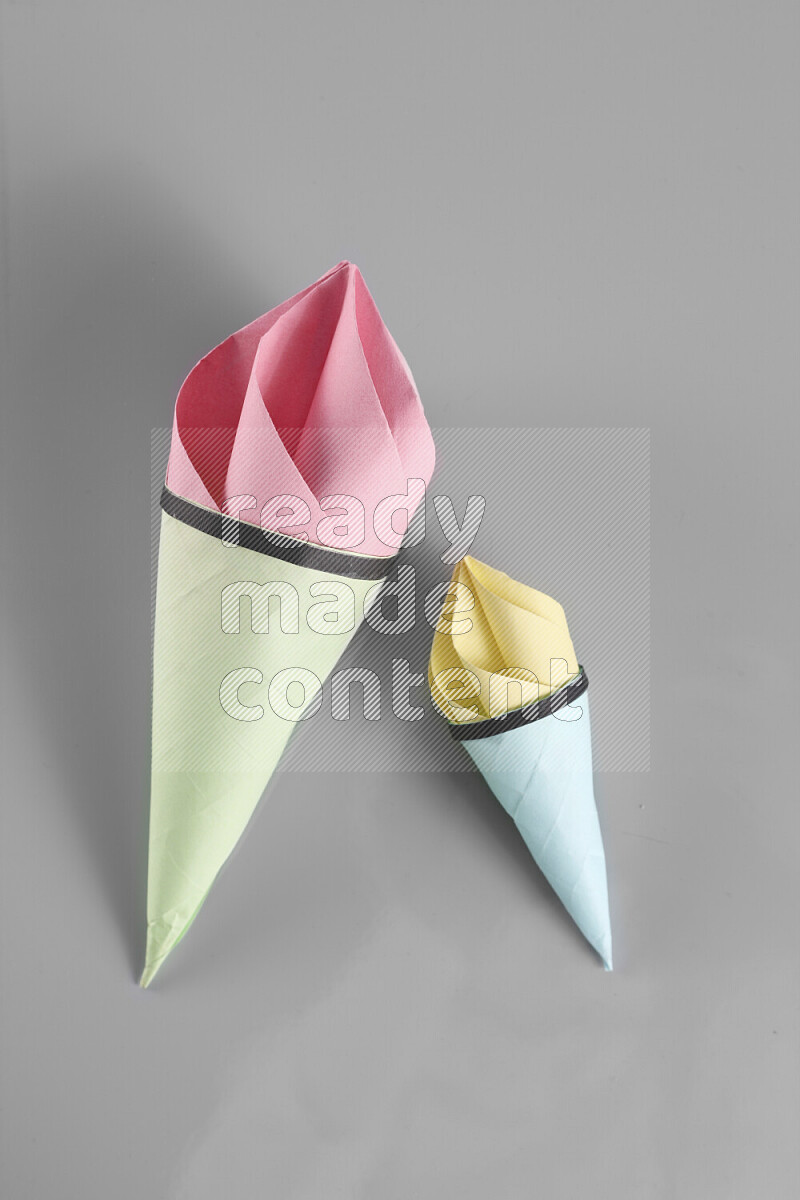 Origami ice cream on grey background
