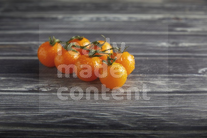 orange cherry tomato vein on a textured grey wooden background 45 degree