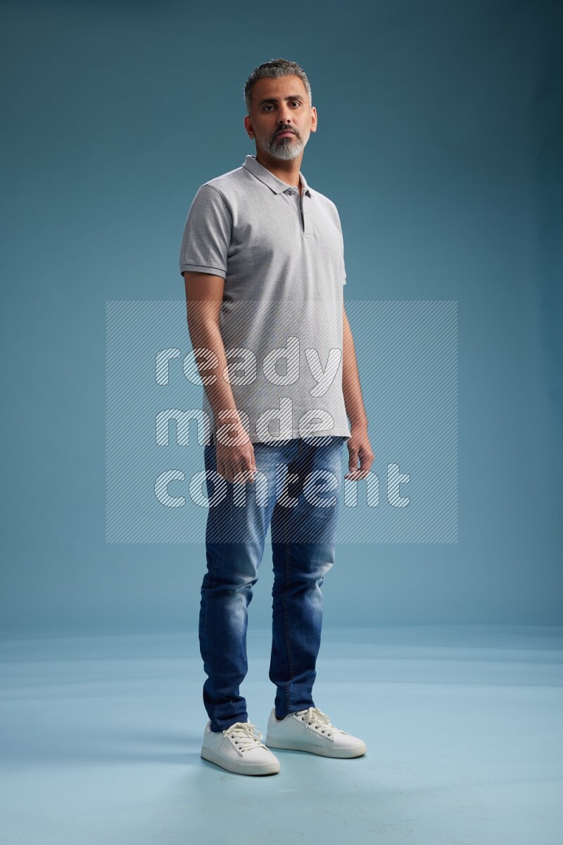 Man Standing Interacting with the camera on blue background