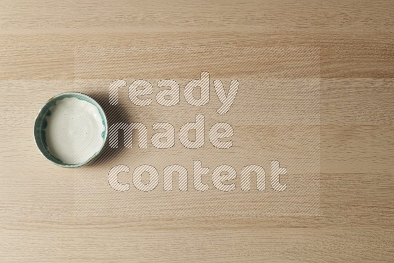 Top View Shot Of A Multicolored Pottery Bowl on Oak Wooden Flooring