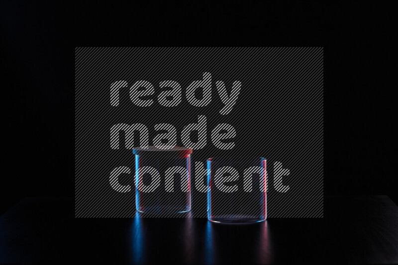 Glassware with rim light in red and blue against black background