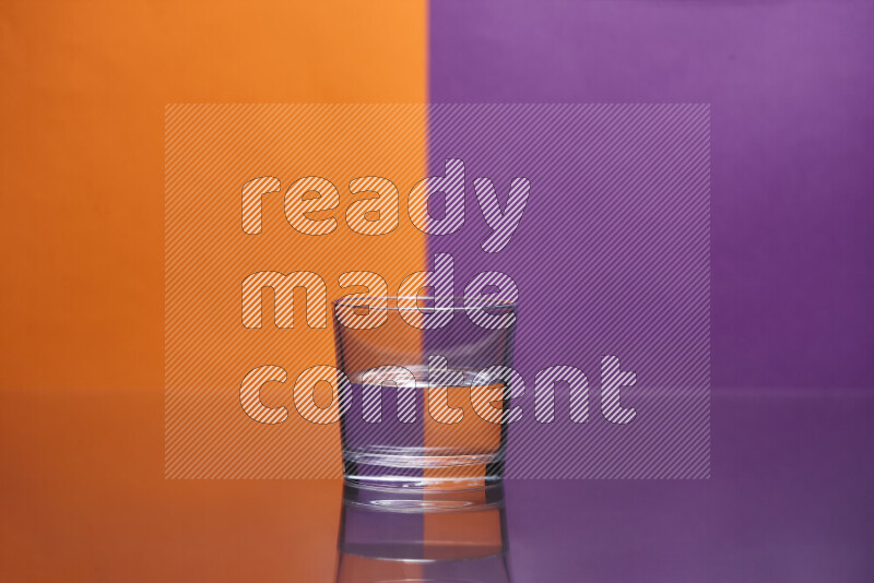 The image features a clear glassware filled with water, set against orange and purple background