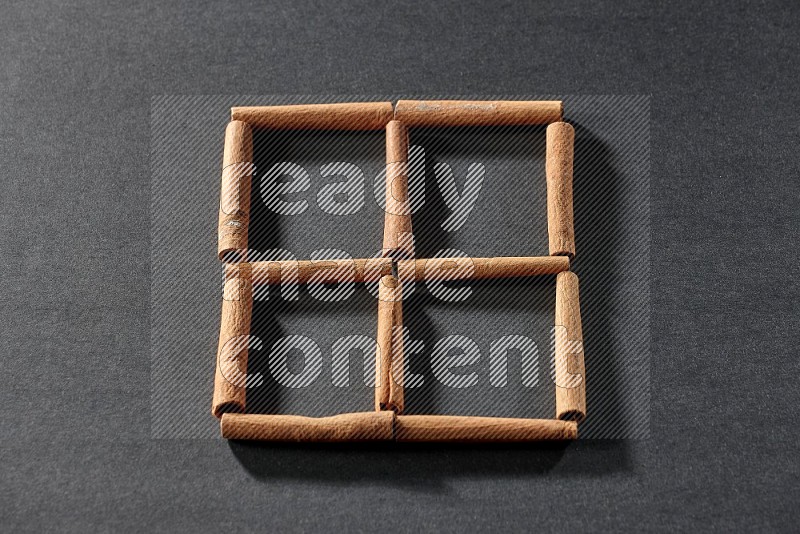 4 squares of cinnamon sticks on black flooring