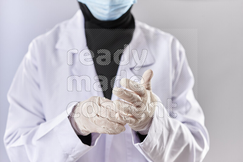 Female doctor wearing an abaya and medical attire in different positions