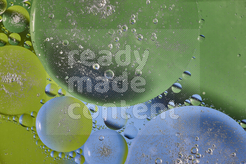Close-ups of abstract oil bubbles on water surface in shades of green and blue