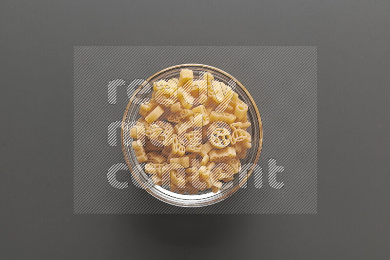 Shaped children pasta on grey background