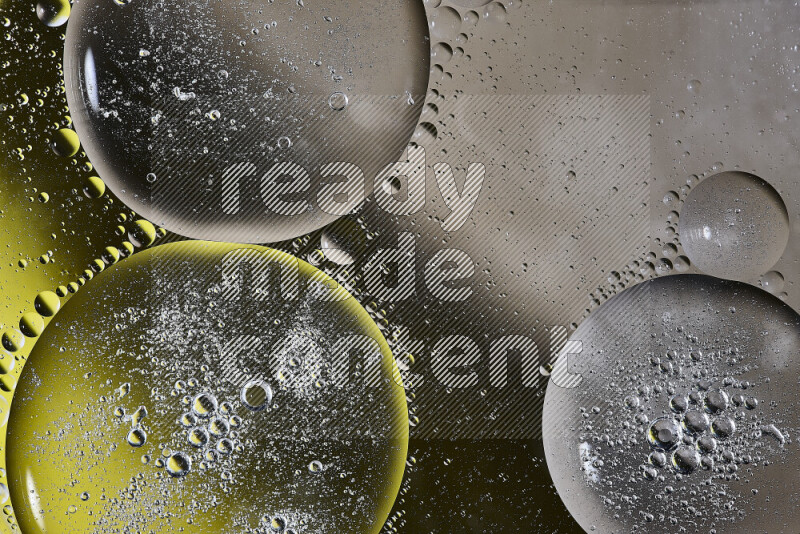 لقطات مقربة لفقاعات من الزيت على سطح الماء باللون البني والأسود والأصفر