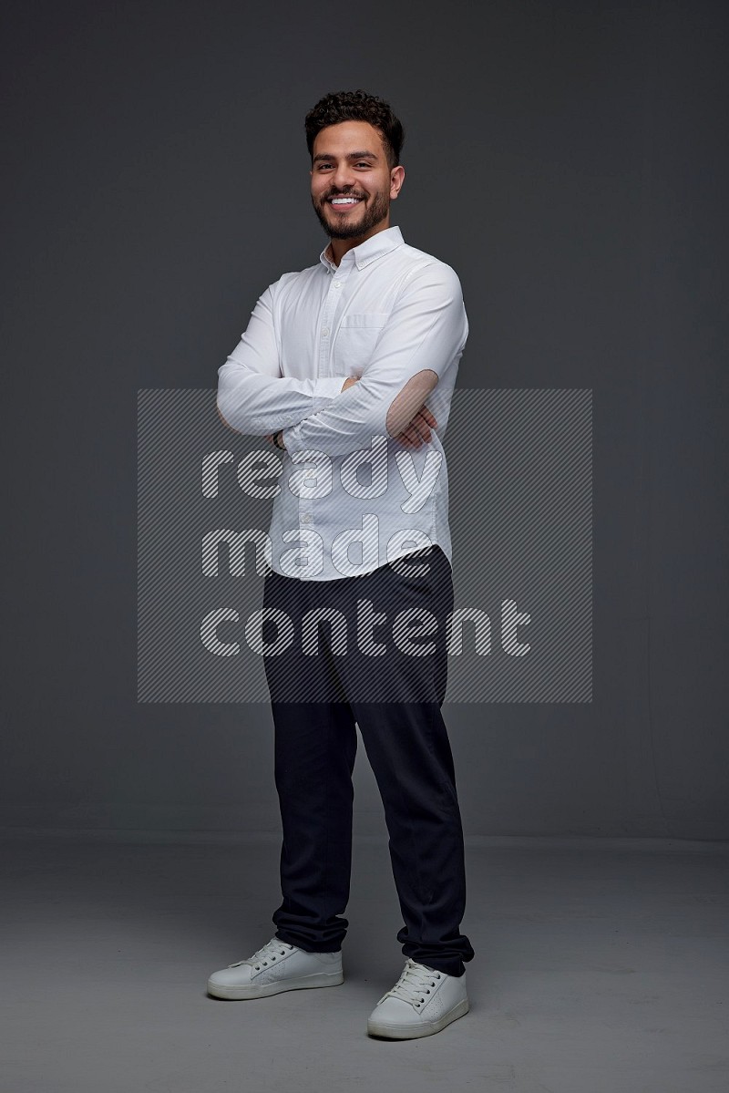 A man wearing smart casual making multi stand poses  eye level on a gray background