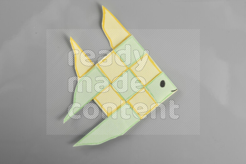 Origami fish on grey background