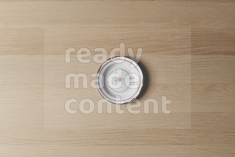 A vintage metal plate on light wooden background