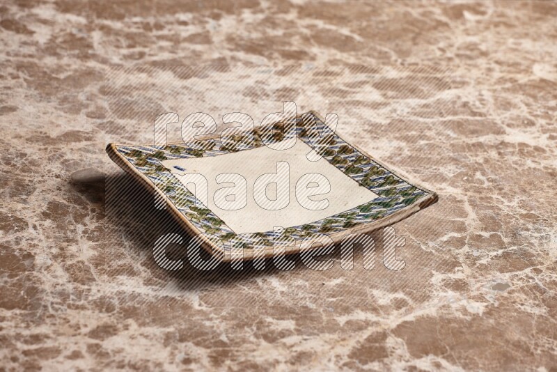 Decorative Pottery Plate on Beige Marble Flooring