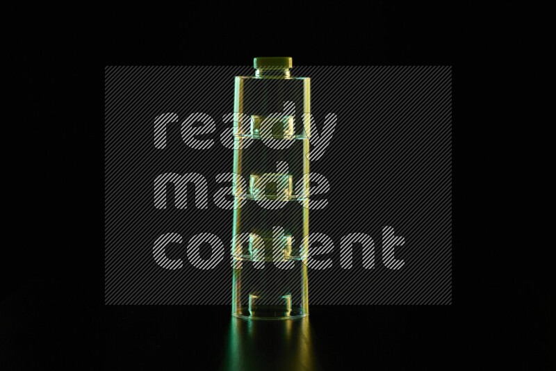 Glassware with rim light in green and yellow against black background