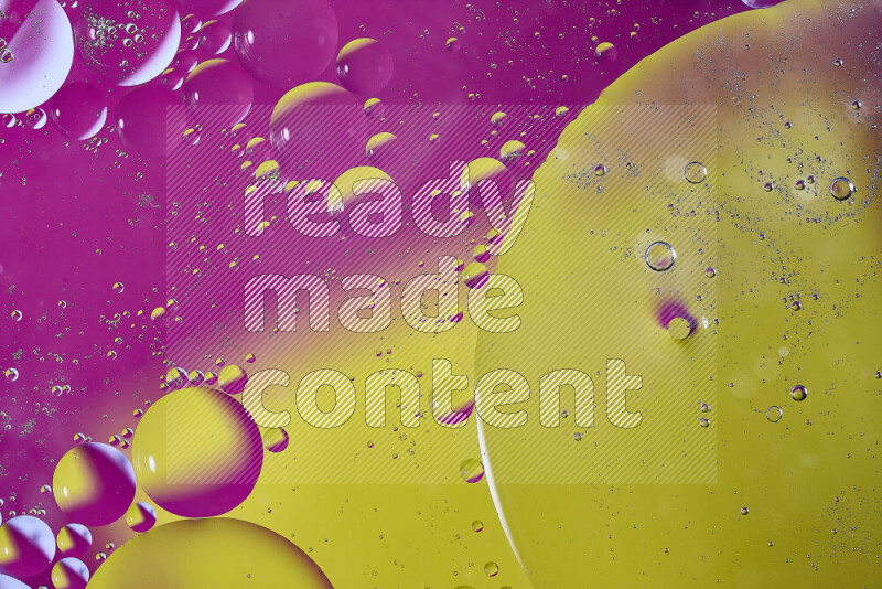 لقطات مقربة لفقاعات من الزيت على سطح الماء باللون الأصفر والوردي