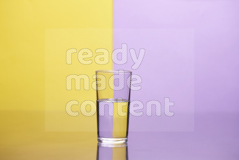 The image features a clear glassware filled with water, set against yellow and light purple background