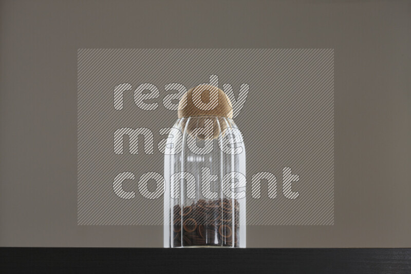 Buttons in a glass jar on black background