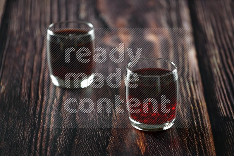 Cold drinks in a glass cup such as water, tamarind, qamar eldin, sobia, milk and hibiscus on wooden background