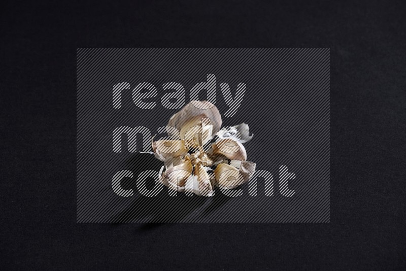 A garlic bulb shaped like flower on a black flooring in different angles