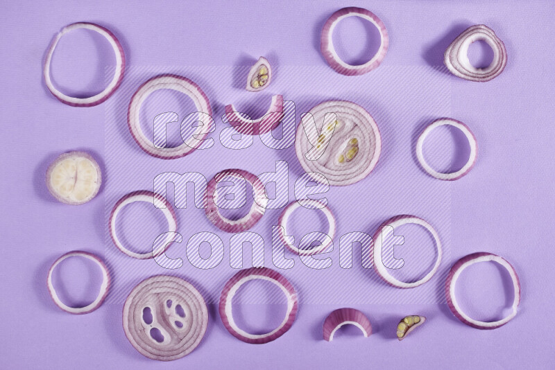 Red onions rings on purple background