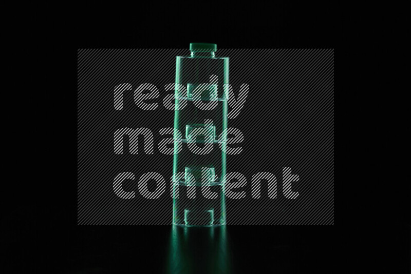 Glassware with rim light in green against black background