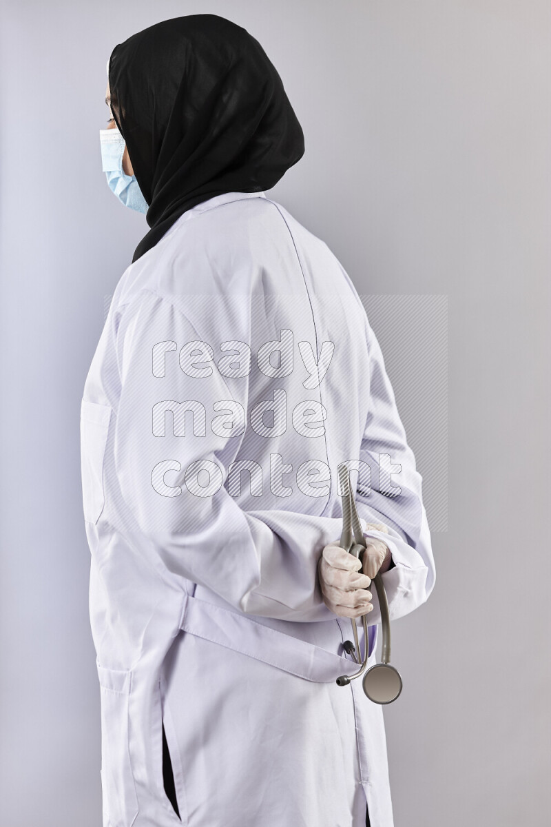 Female doctor wearing an abaya and medical attire in different positions