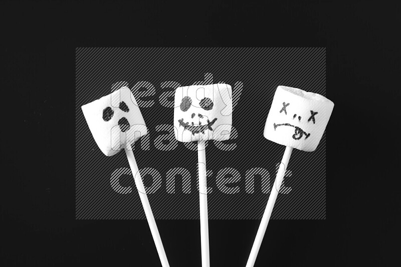 Halloween shapes on marshmallows on black background