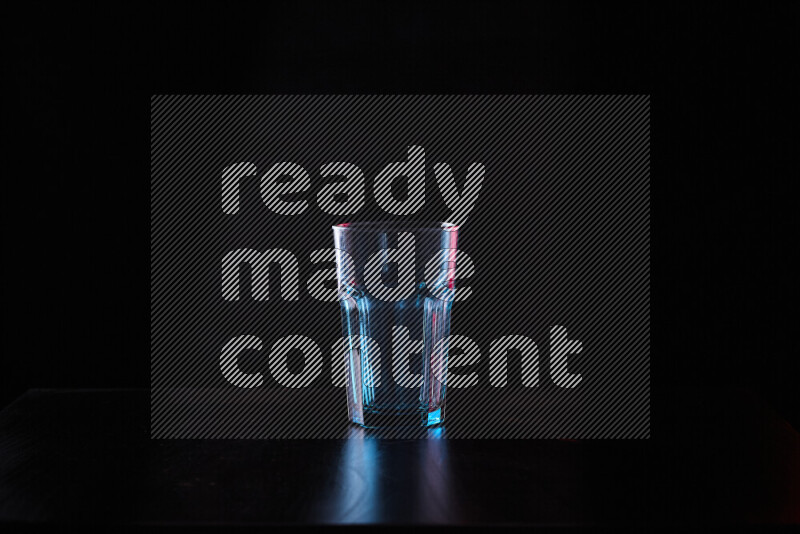 Glassware with rim light in red and white against black background