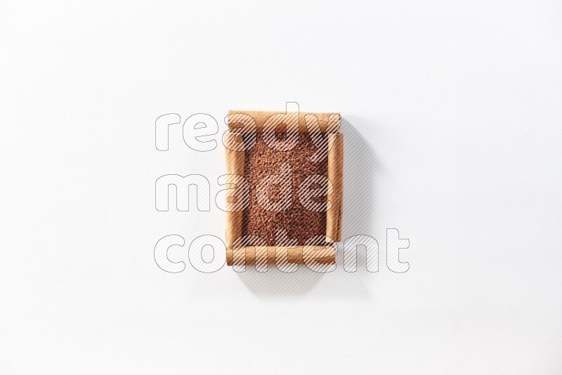 A single square of cinnamon sticks full of garden cress on white flooring