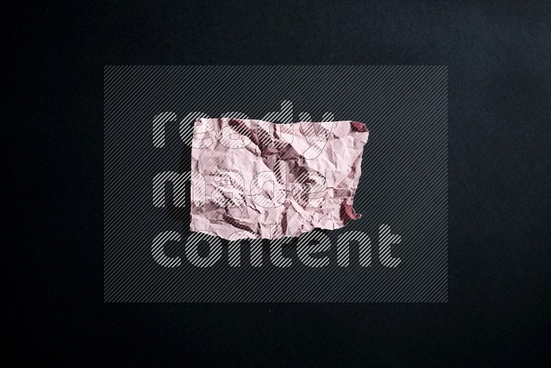 Pink paper sheet on black background