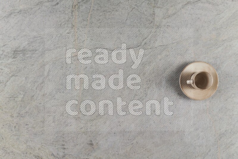 A multicolored pottery Cup on grey marble background