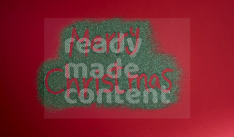 A sentence written with green glitter on red background