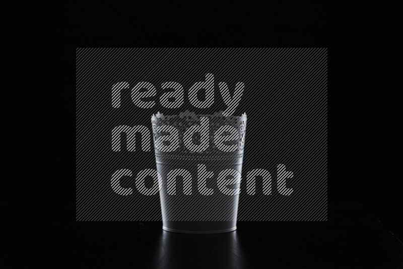 A plant pot with colored rim light against black background