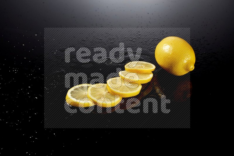 Lemon slices with water drops, and droplets on black background