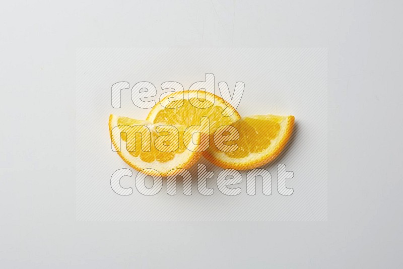 Three halves of an orange slices on white background