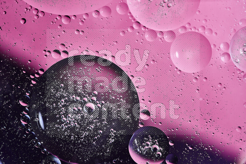 Close-ups of abstract oil bubbles on water surface in shades of purple and pink