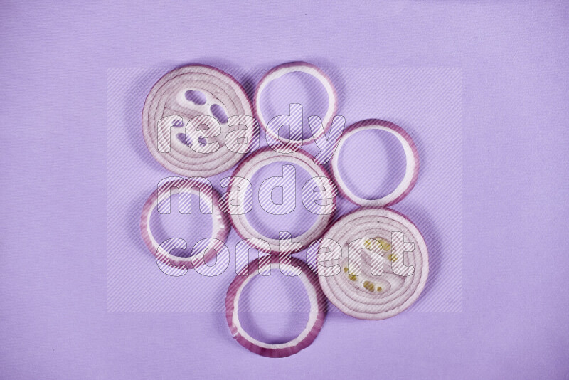 Red onions rings on purple background