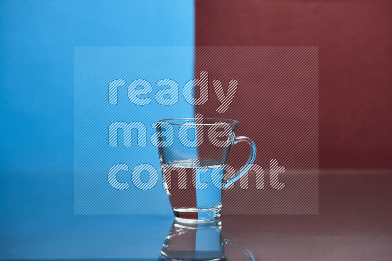 The image features a clear glassware filled with water, set against blue and dark red background