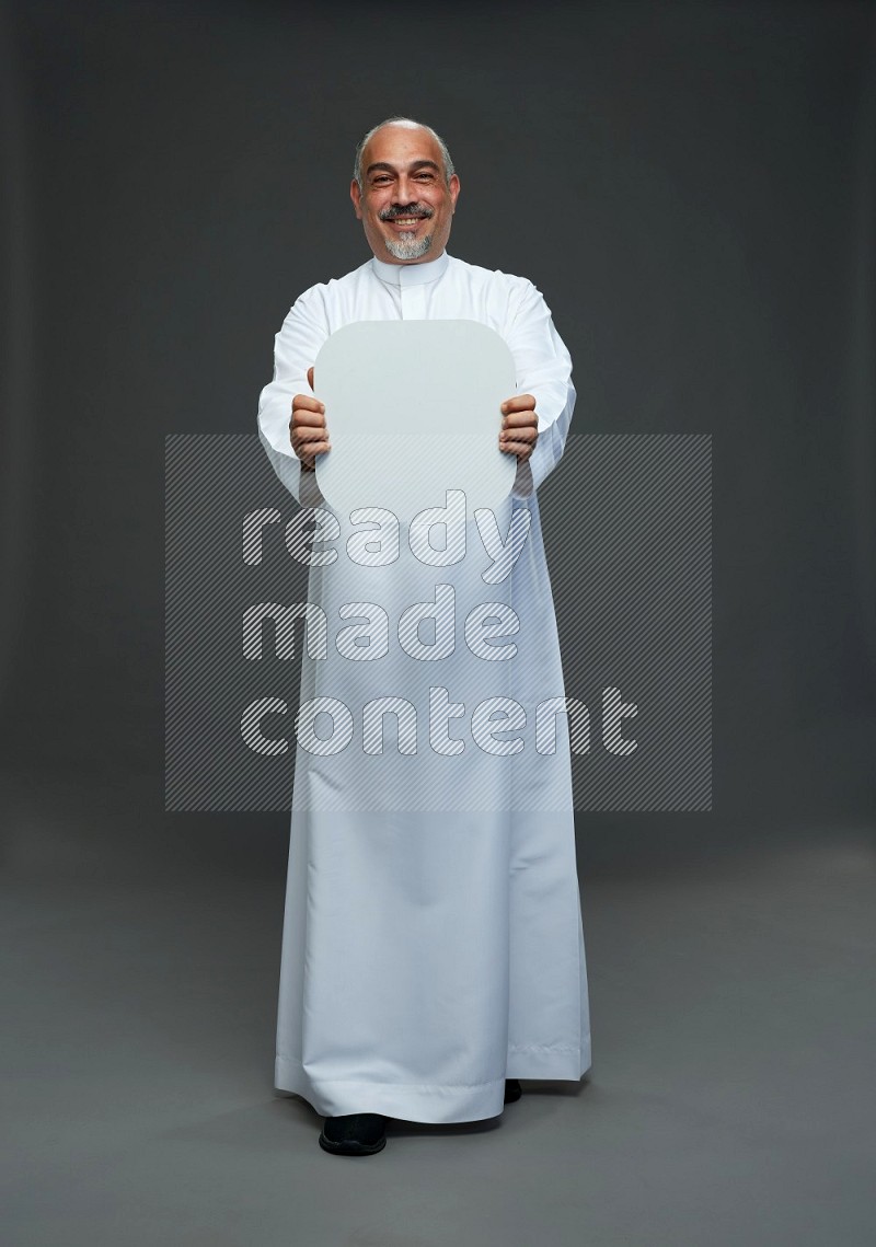 Saudi man without shomag Standing holding social media sing on gray background