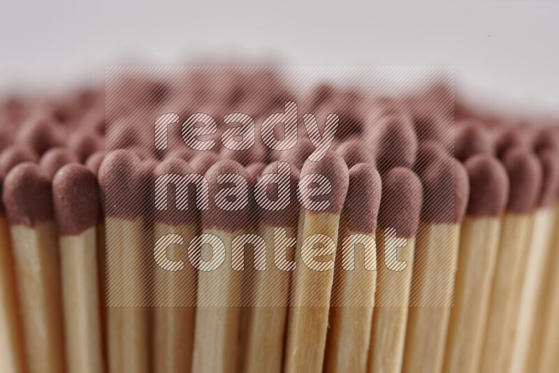 A close-up of a bundle of matches on grey background
