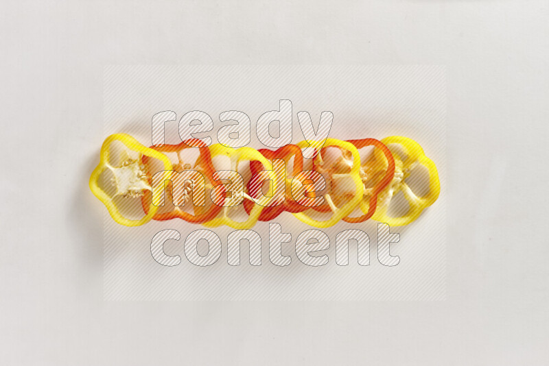 Assorted bell pepper slices on white background