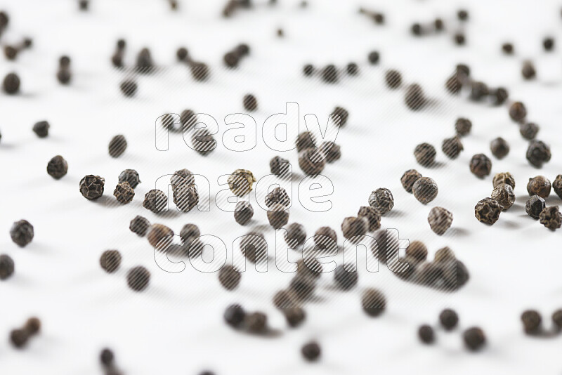 Black pepper beads on white background