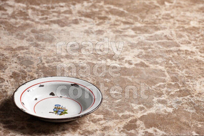 A vintage metal plate on beige marble background