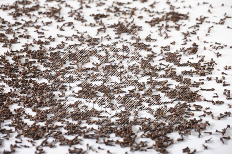 Cloves spread on white flooring