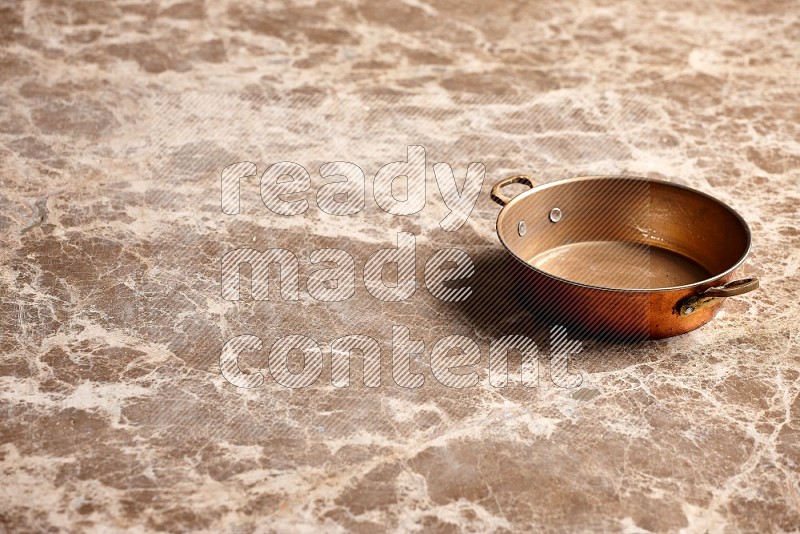 Small Copper Pan on Beige Marble Flooring, 45 degrees