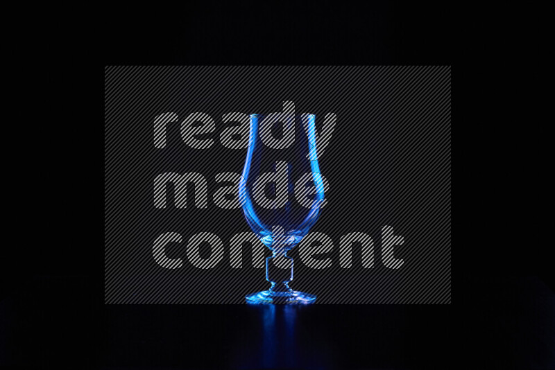 Glassware with rim light in blue against black background