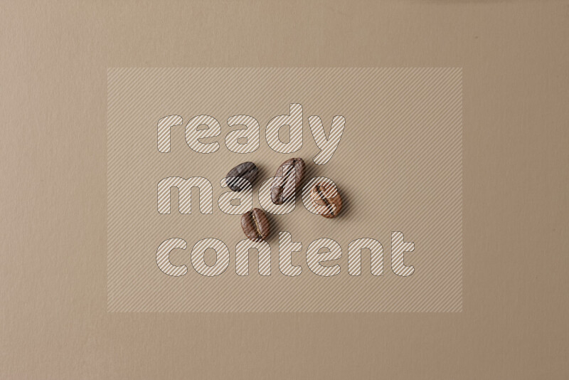 Roasted coffee beans on beige background