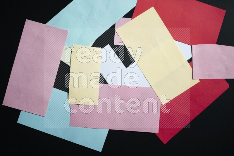 Multicolored paper sheet on black background